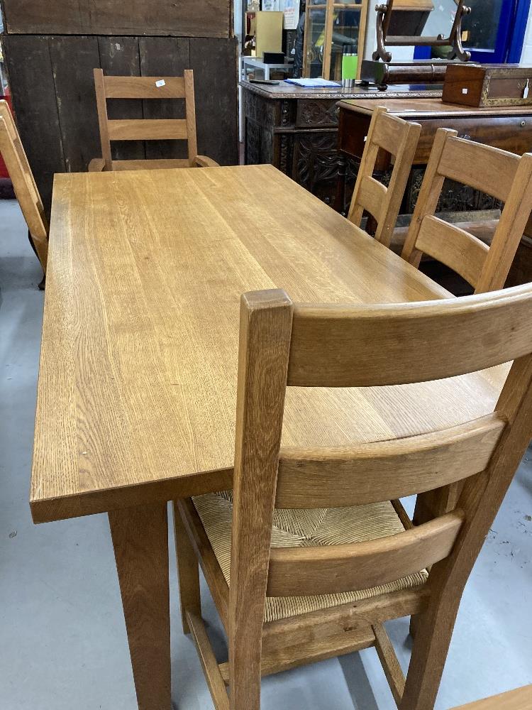 Good quality solid oak modern extending dining table with a set of matching four ladder back