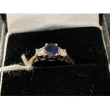 Hallmarked Jewellery: Ring, three stone claw set in white with a single oval cut sapphire, estimated