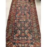 Carpets & Rugs: Late 19th cent. Persian wool runner with red ground, stylised flowers in blues,