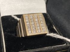 Jewellery: Yellow metal ring with a square top body with twenty four brilliant cut diamonds,