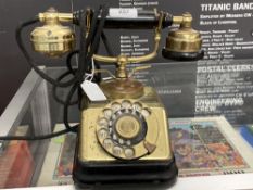 Early 20th cent. Danish brass and bakelite, finger dial telephone.