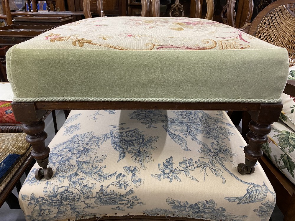 19th cent. Two large mahogany footstools with floral cushioned upholstery.