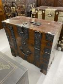 19th cent. Chinese hardwood campaign chest, fall front with decorated iron mounts and carrying