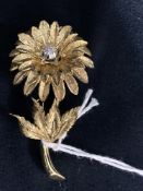 Jewellery: Yellow metal flower brooch set with seven brilliant cut diamonds, estimated weight of (7)