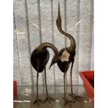 White metal figurines, cranes white metal legs and neck, the body made of polished wood, standing on