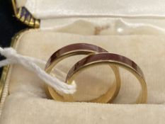 Jewellery: Rings, yellow metal inlaid with red enamel, test as 18ct, a pair. Weight 7.4g.