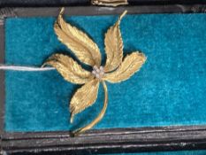 Jewellery: Yellow metal brooch, leaf design centre set with six brilliant cut diamonds, estimated