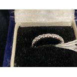 Jewellery: White metal ring set with twenty two 2mm brilliant cut diamonds, estimated weight of (22)