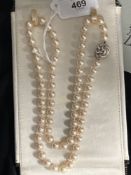 Jewellery: Necklet single row of (69) 7.5mm cultured pearls with a white metal knotted 14mm circular