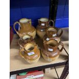 Doulton Lambeth: Stoneware harvest jugs. Six graduated jugs. Two A/F. From 5ins. to 8¼ins.