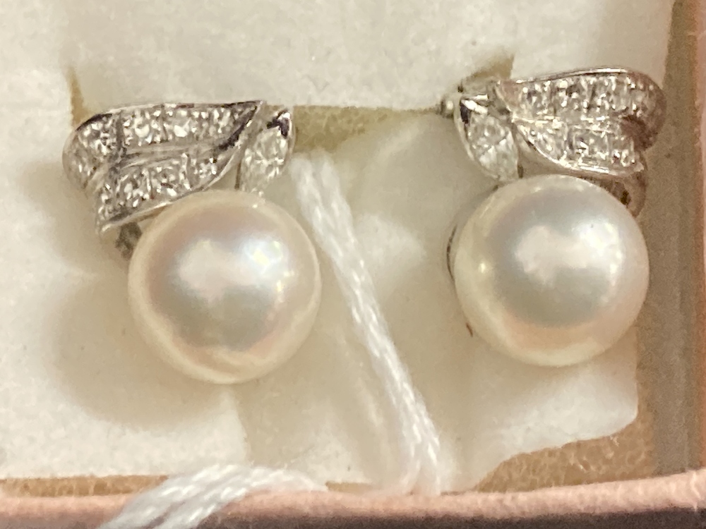 Jewellery: White metal earrings each set with a single 8mm cultured pearl and ten brilliant cut