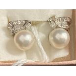 Jewellery: White metal earrings each set with a single 8mm cultured pearl and ten brilliant cut