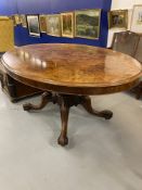 19th cent. Birds eye maple tilt top table on a single column support with four splayed feet on