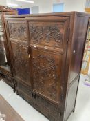 20th cent. Chinese hardwood compound cabinet carved with high relief stylised Chinese scenes. 47½