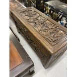 Chinese camphor wood blanket box decorated with a battle scene. 21ins. x 47ins.