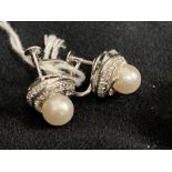 Jewellery: White metal earrings each set with an 8mm cultured pearl and twenty six brilliant cut