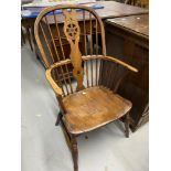 Late 18th cent. Oak and elm Windsor hoop wheel back armchair.