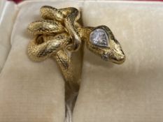 Jewellery: Yellow metal ring in the form of a snake, set with a single brilliant cut diamond,