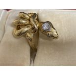 Jewellery: Yellow metal ring in the form of a snake, set with a single brilliant cut diamond,