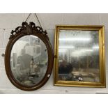 Mirrors: 19th cent. Oval in mahogany frame surmounted by scroll carving, 28½ins. x 21ins. Plus a