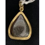 Jewellery: Sino-Asian Buddha rock crystal yellow metal mounted tests 18ct, depicting the Buddha