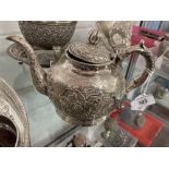 Chinese white metal export silver teapot tests 800 standard, floral repousse decoration. Approx.