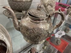 Chinese white metal export silver teapot tests 800 standard, floral repousse decoration. Approx.