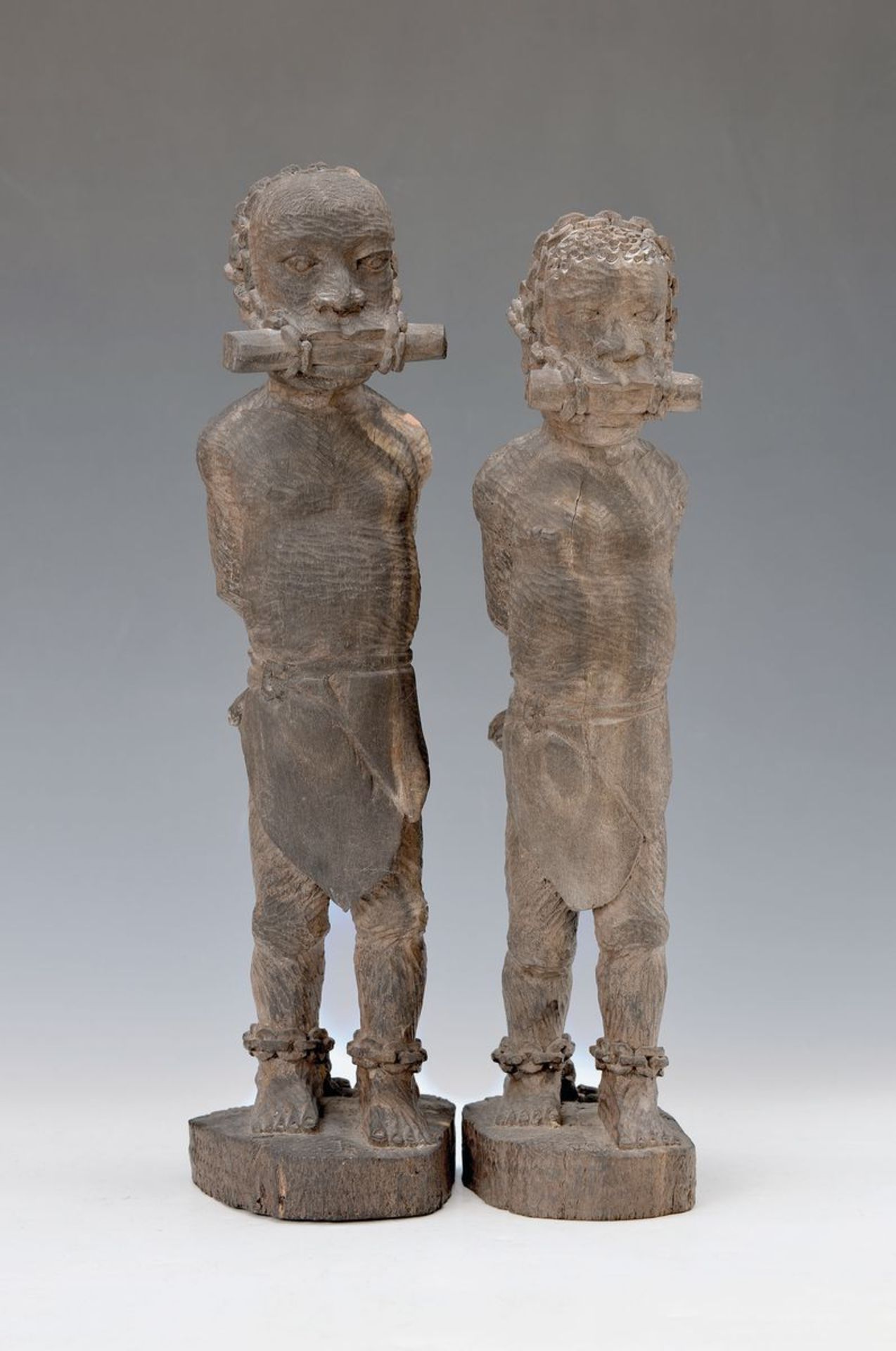 couple of slaves figures, colonial art, probably Cameroon, around 1900, heavy wood, slaves in