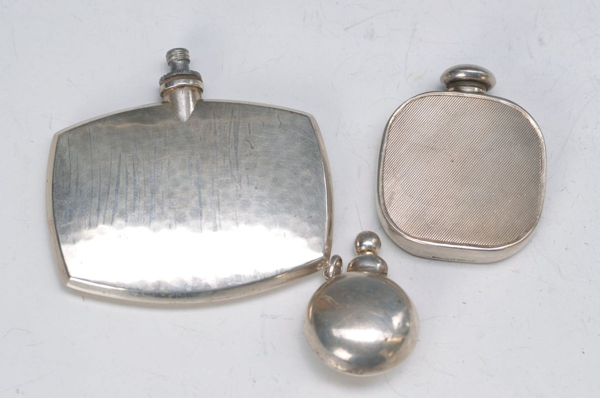 3 snuff bottles, German, around 1920-30, silver, one with hammered decoration, 835 silver, without