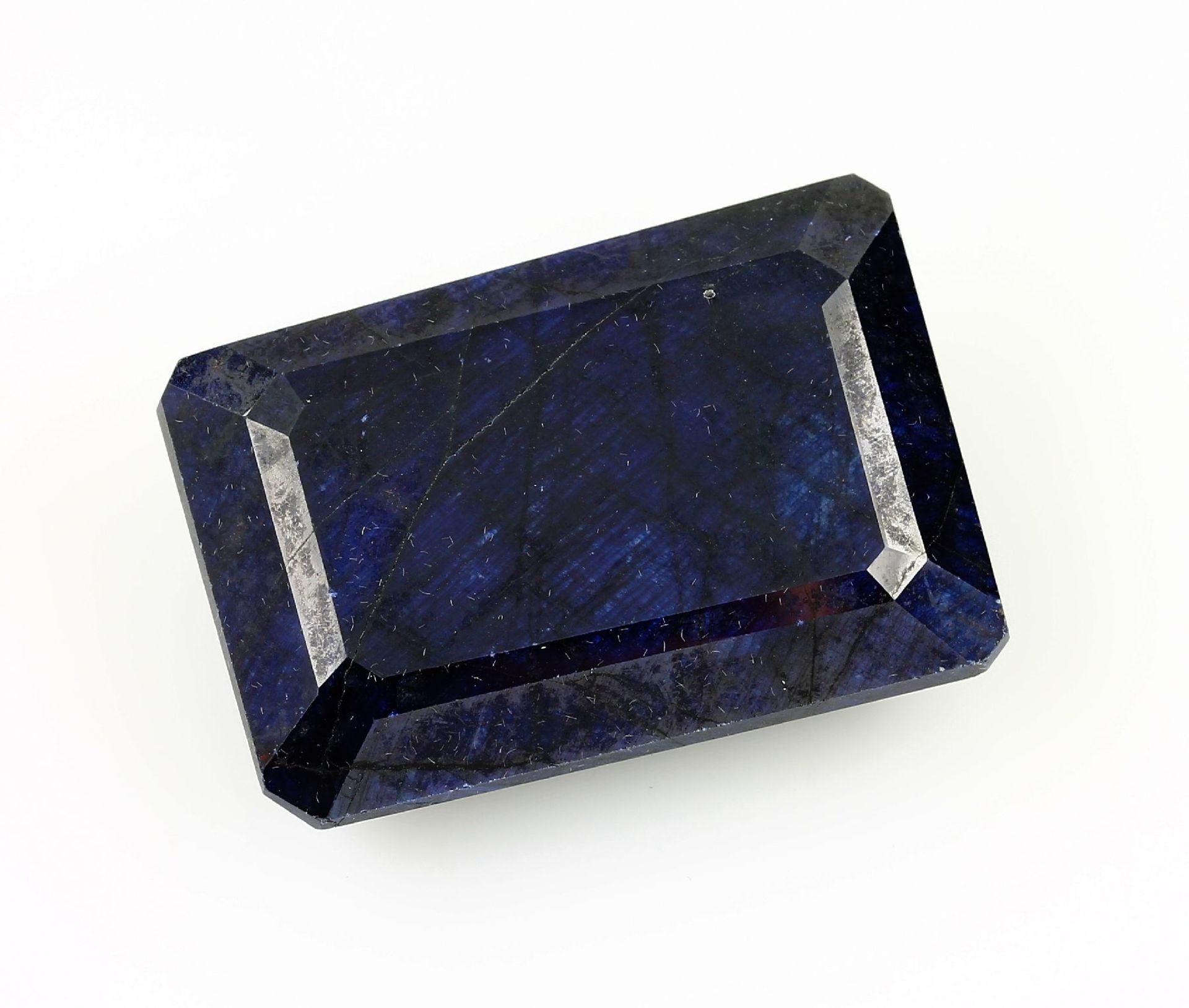 Loose sapphire , approx. 260.05 ct, weighted, treated, rectangularly bevelled, approx. 4 x 3 x 1.5