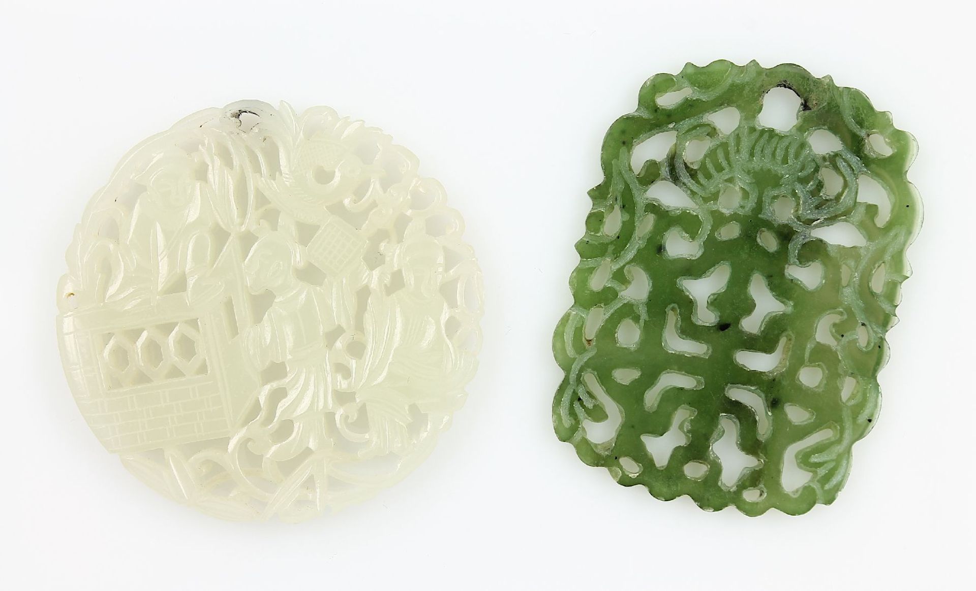 Lot 2 jade discs , total approx. 187.09 ct, with fret work, geschn., polished, 1 x people,1 x