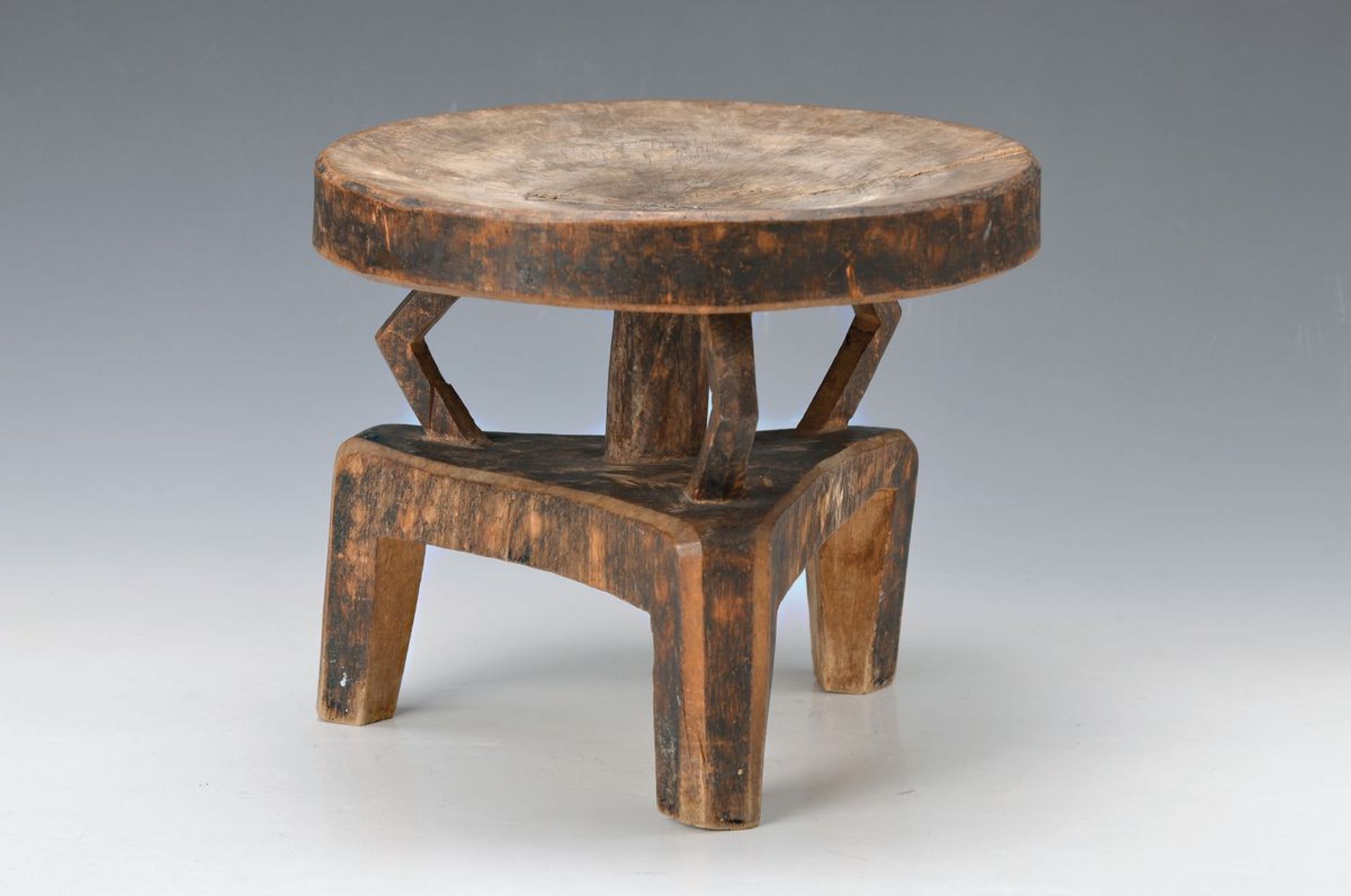 stool of the Senufo, 20th c., wood, three- legged with three bent props, H. approx. 25cm,D.