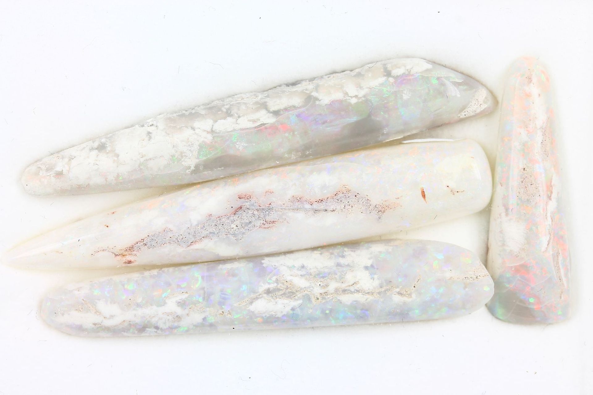 Lot 4 loose opal belemnites , comprised of: 1 x approx. 32.2 ct, approx. 57.6 x 9.9 x 9.6 mm, 1 x