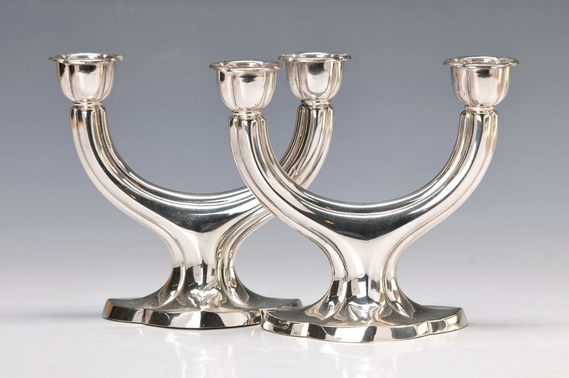 A pair of candlesticks, German, Middle of 20thc., each two focal points, 835 silver, 15 x 16.5 cm,