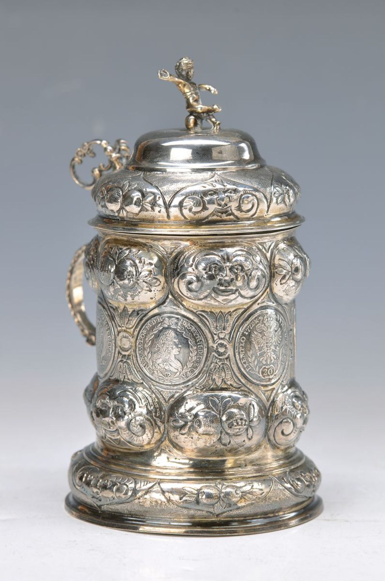 lidded stein with Austrian coins of 1750-72, silver, jar around 1880, partly gilt, with faces and