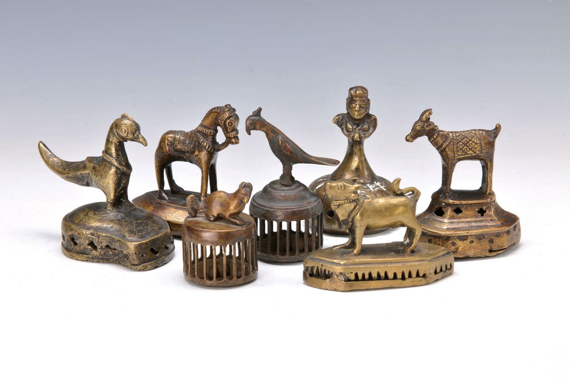 7 sound-small bells, South India, around 1900,brass, with different fully plastic animals ashandles,