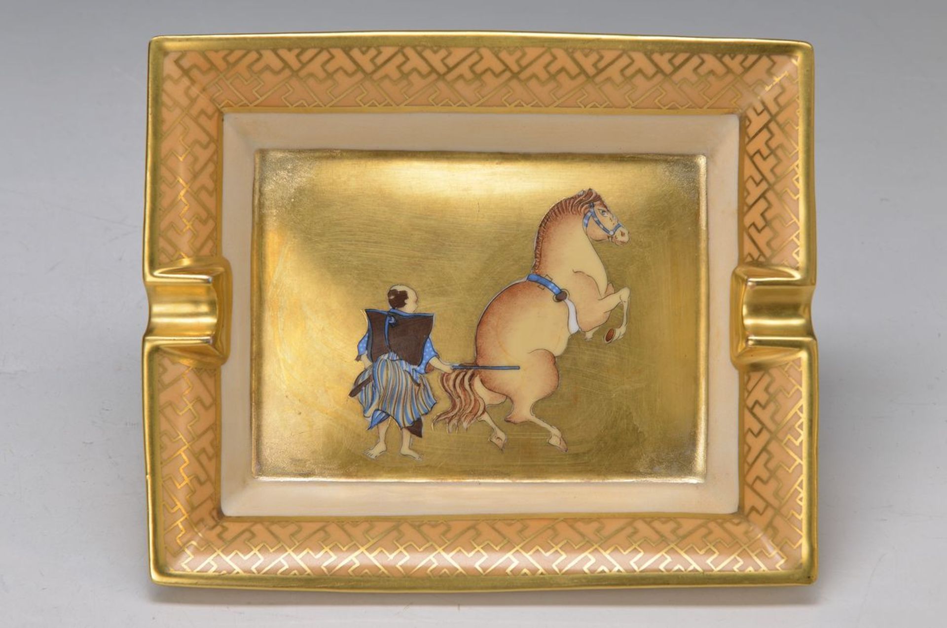 ash-tray, Hèrmes Paris, porcelain, richly gilt, motif of Samurai with horse, approx. 3x19.5x16.