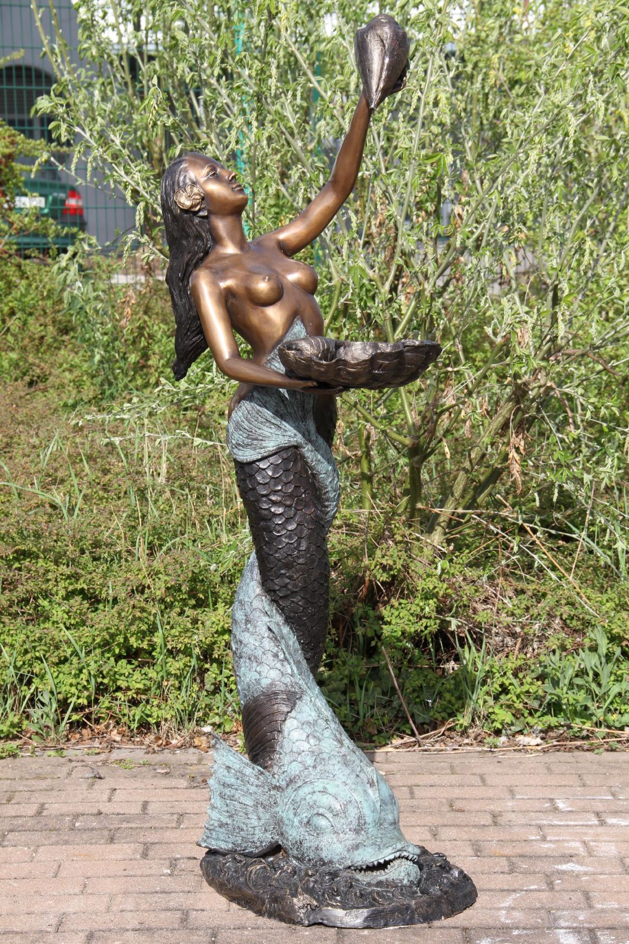 Mermaid on dolphin as a fountain figure, bronze, brown, golden brown and greenish patinated, water