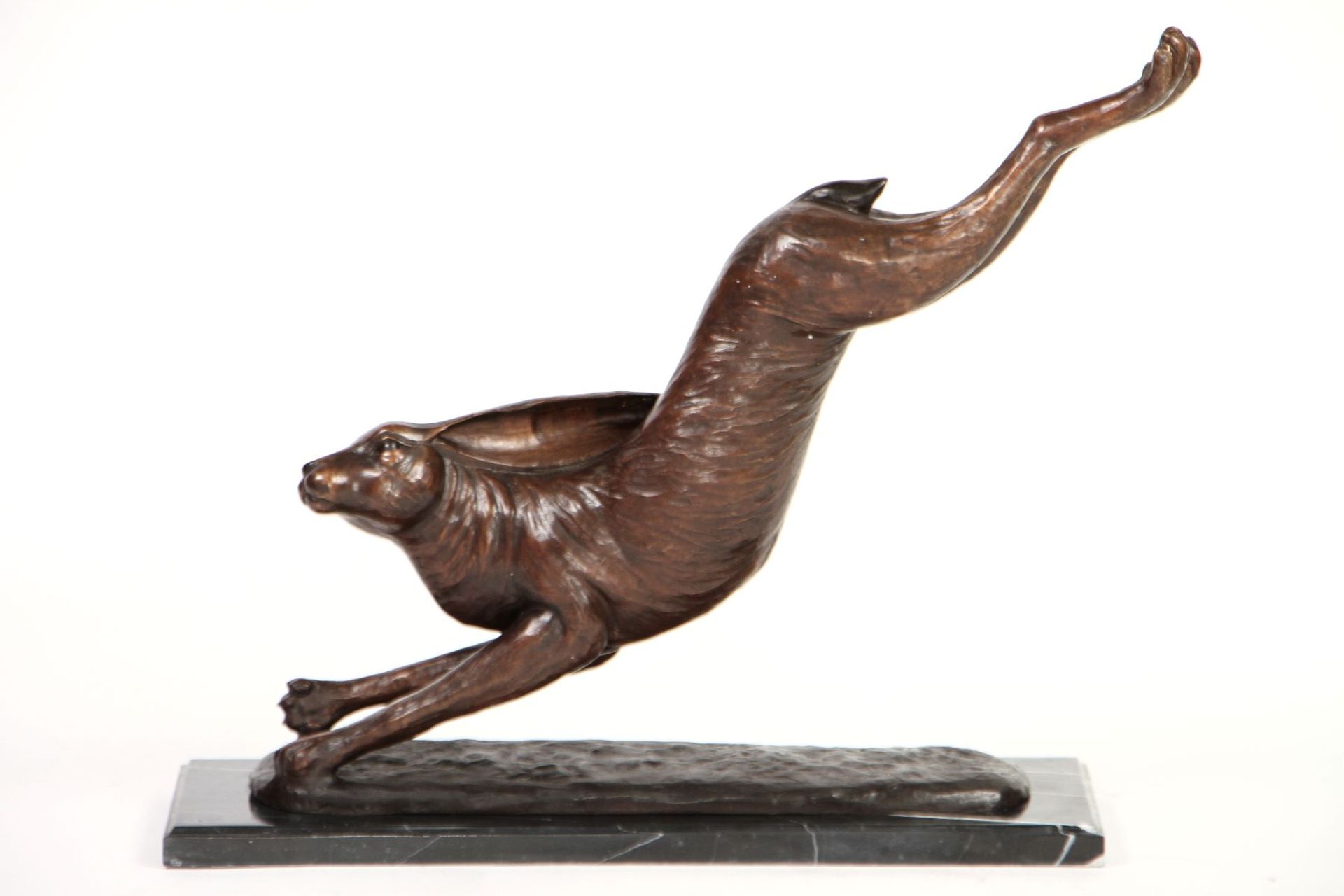 Rabbit, bronze, patinated brown-golden and brown, on black marble plate, approx. 69x25x86cm, approx.