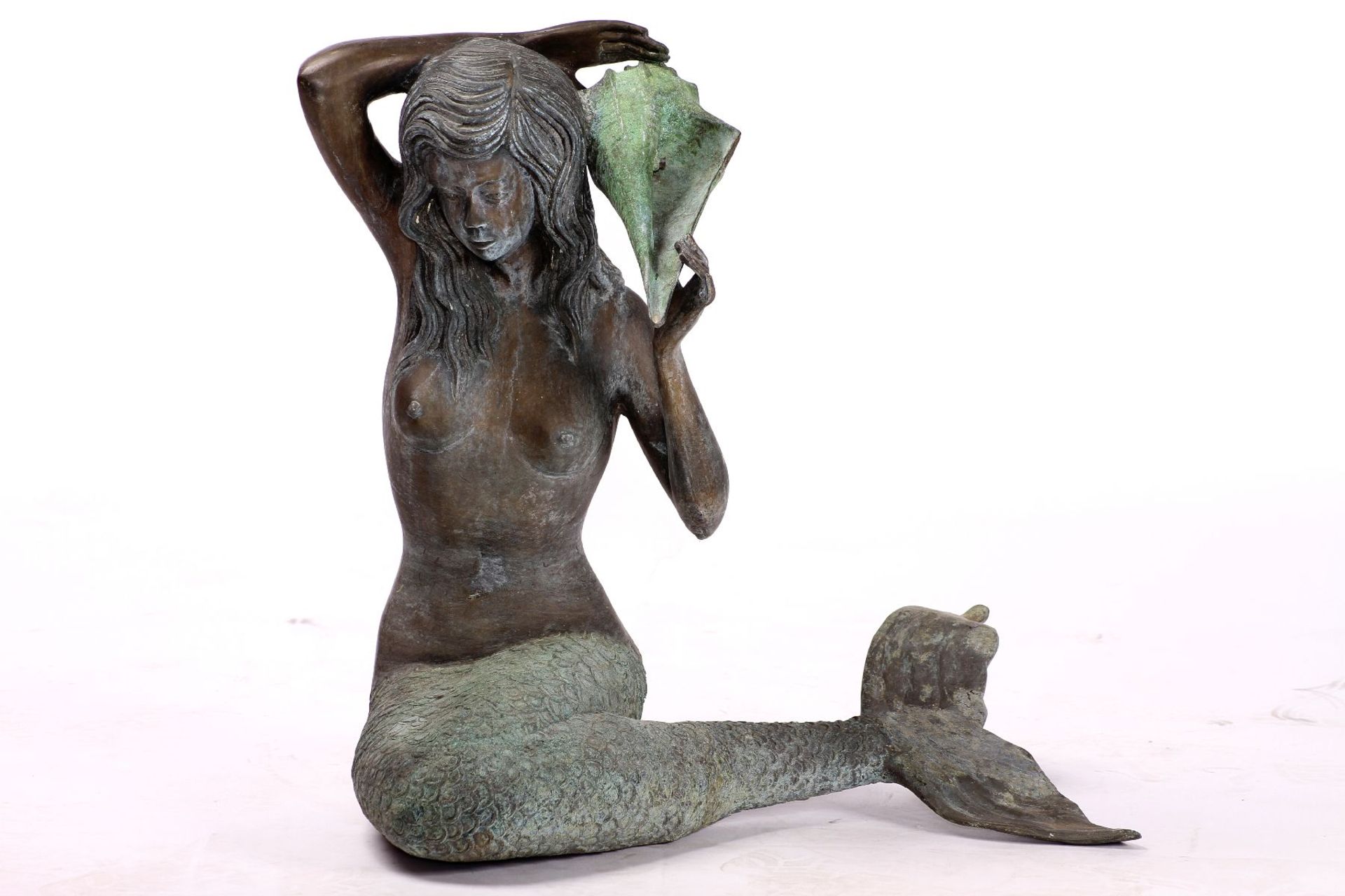 Sitting Mermaid as a Fountain Figure, bronze, green and golden brown patinated, orientated the left,