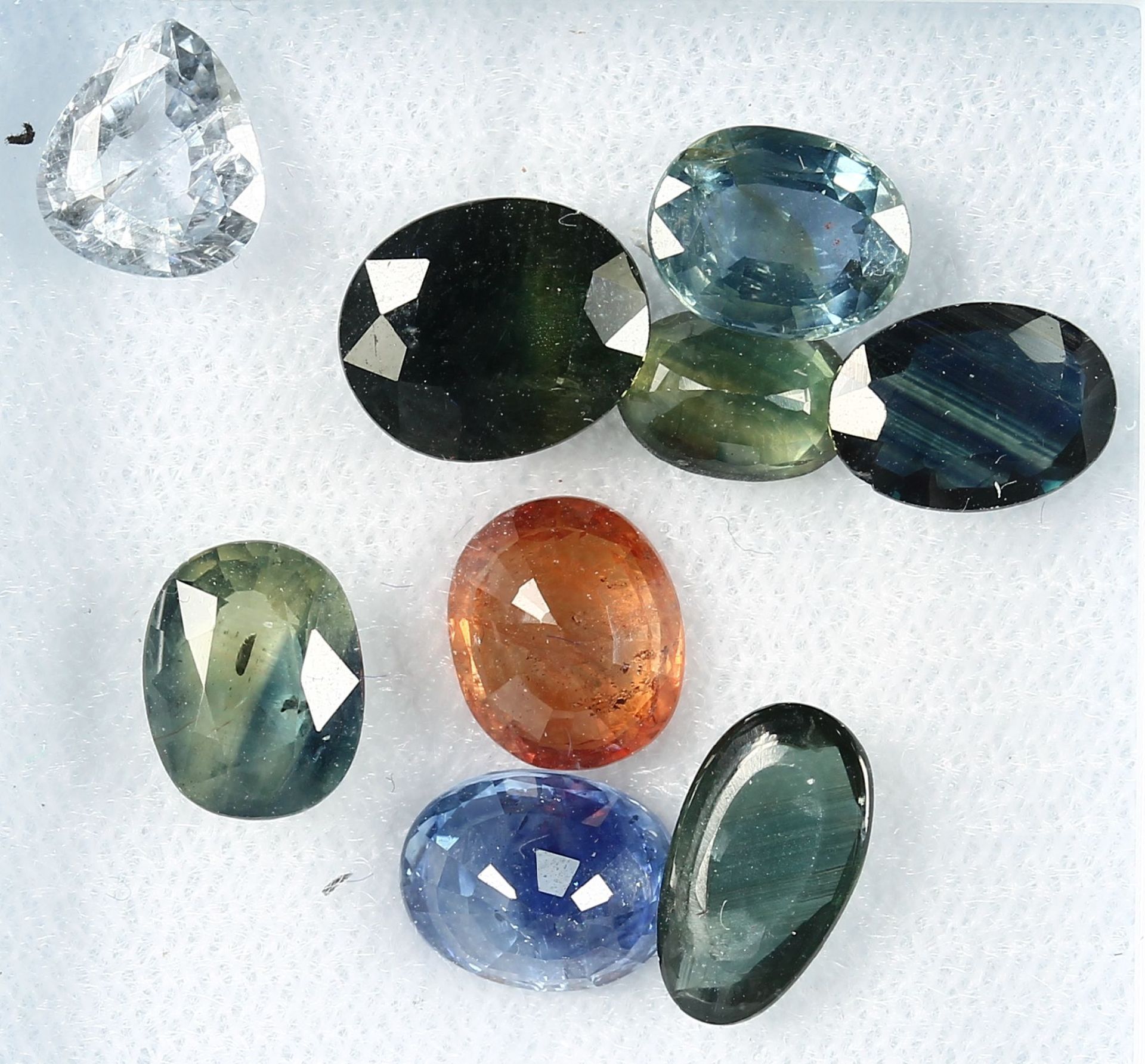 Lot 9 loose bevelled sapphires , total 15.83ct, in different colours, shapes and sizes Valuation