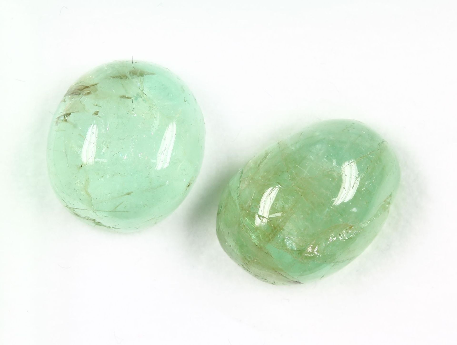 Lot 2 loose emerald cabochons , total 28.23 ct, 1 x round, 1 x oval, inclusions Valuation Price: