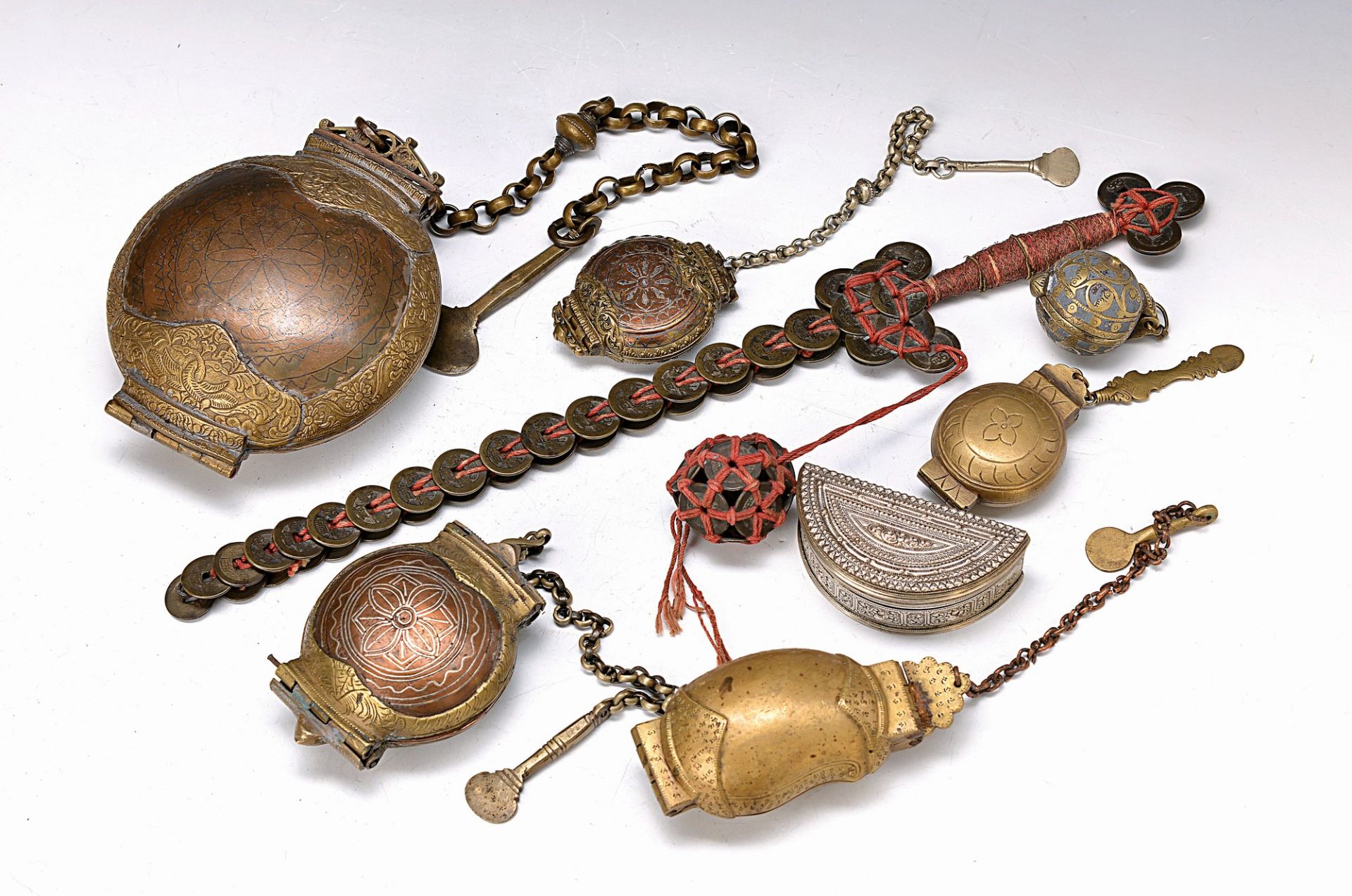 12 metal vessels for chalk or Betel, Indonesia, 19th c. and one "ghost sword", vessels of metal,