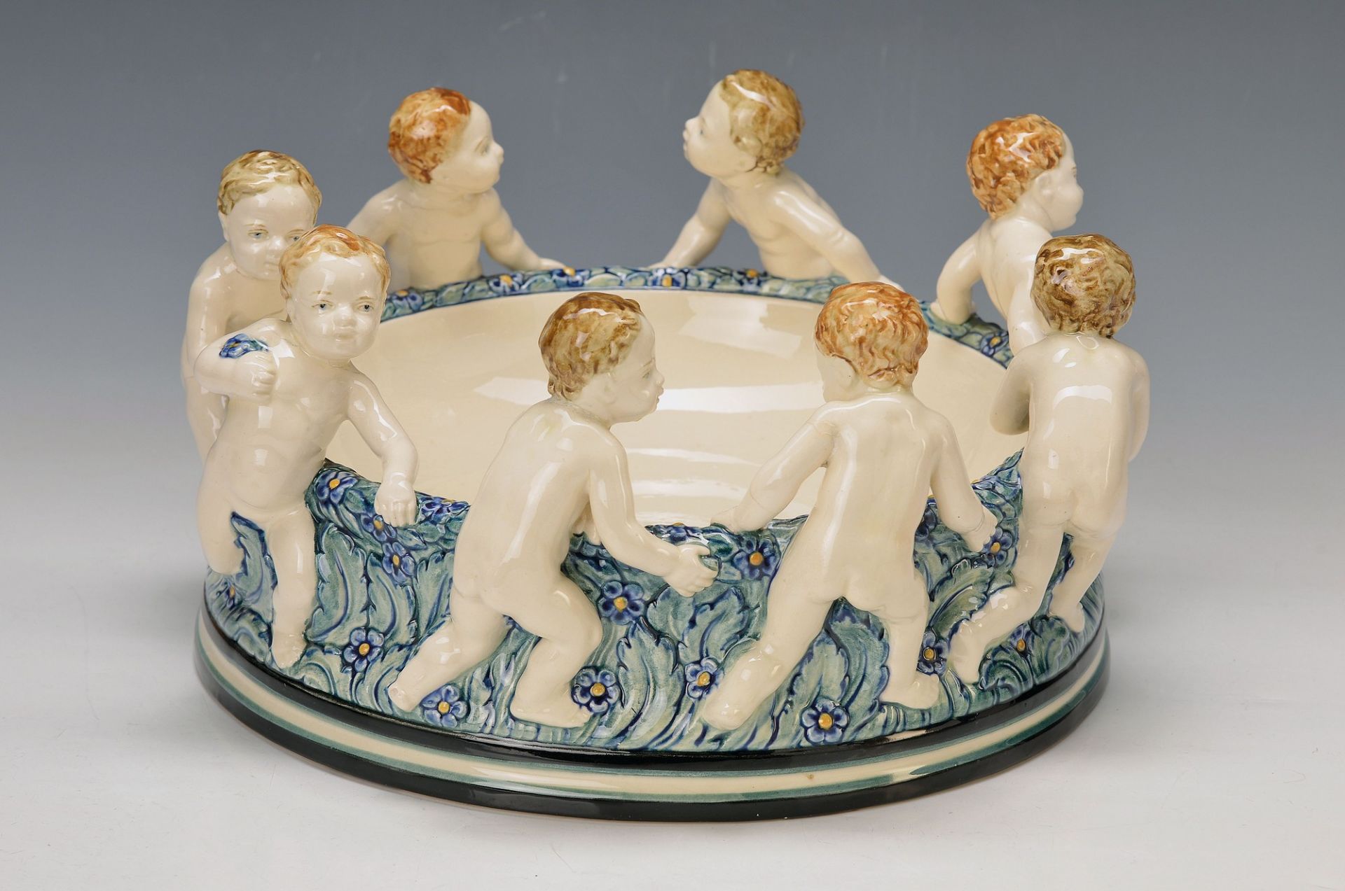 Large bowl, Karlsruher majolica, designed by Süs, 8 children in dance, 4 heads restored , H. approx.