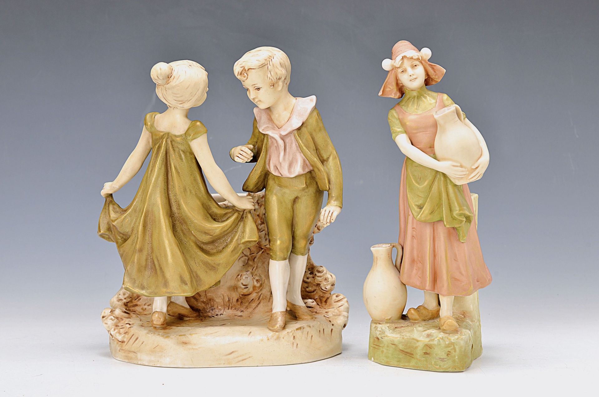 two figurines, Royal Dux, around 1900/10, vase with figure crest, dancing couple of children,