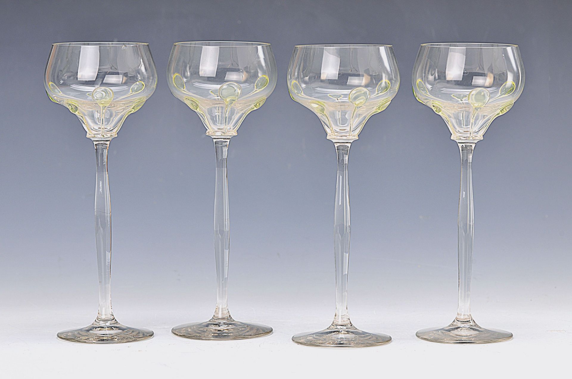 7 Art Nouveau glasses, around 1910, colorless glass with green naps, H.approx. 21 cm, 2x minor on