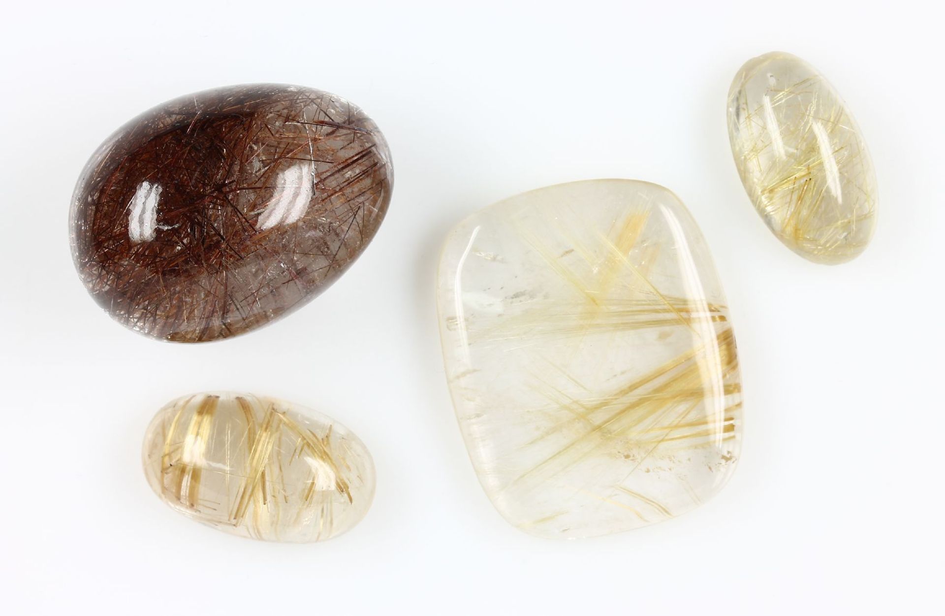 Lot 4 quartzes with rutile inclusions , total approx. 400 ct, 3 x gold coloured, in different