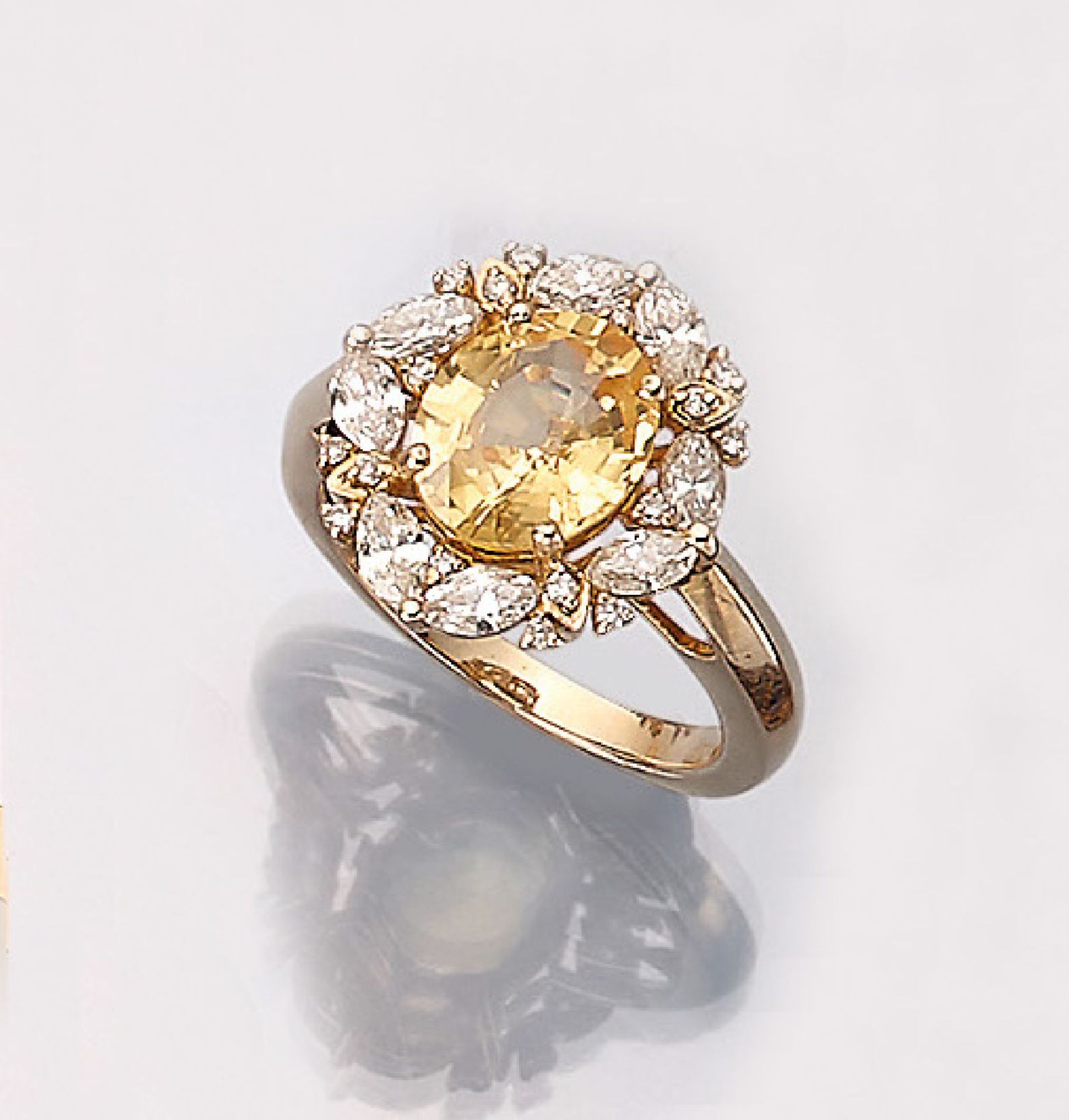 14 kt gold ring with sapphire and diamonds ,YG 585/000, centered with one oval bevelled yellow