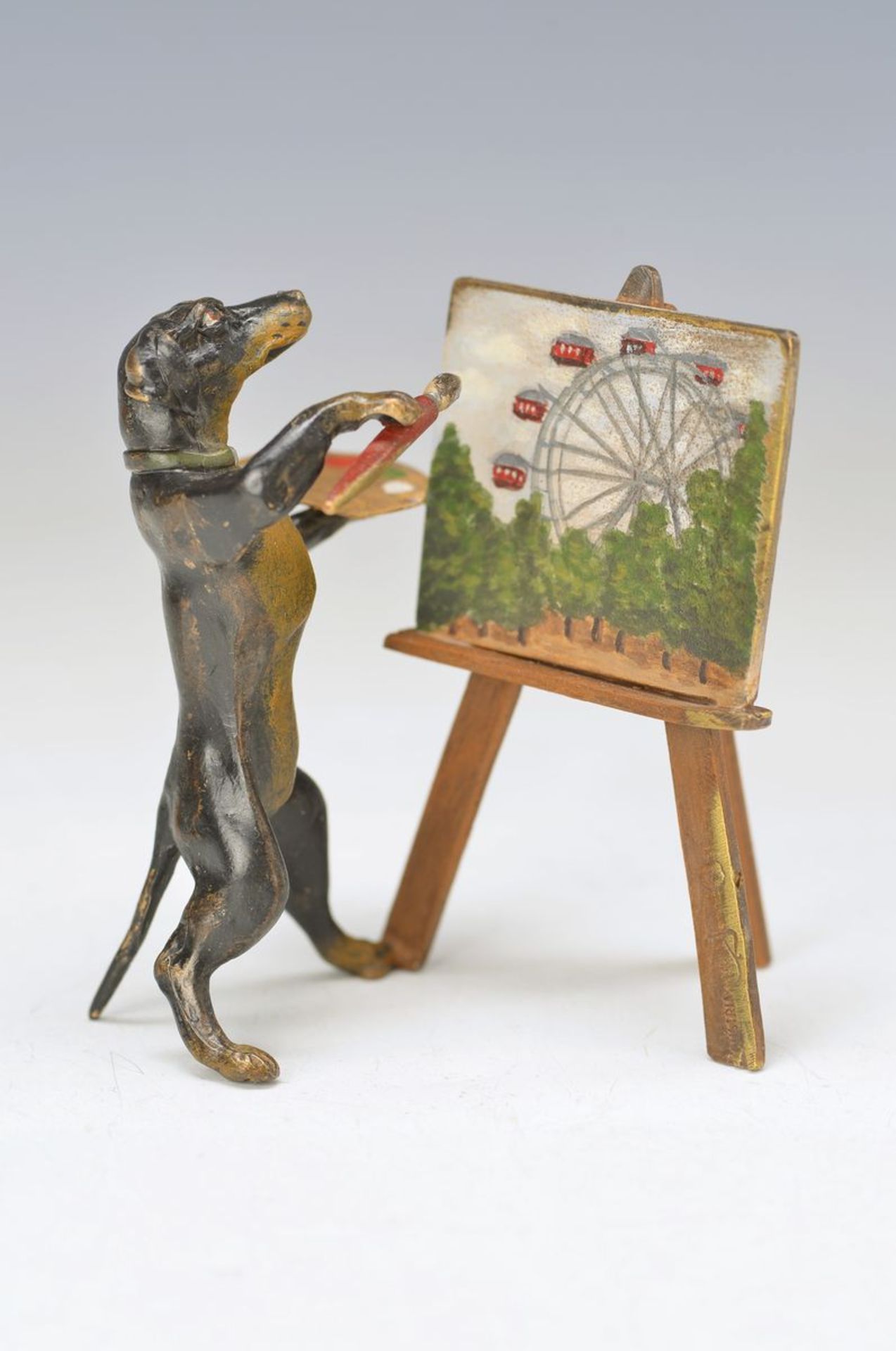 Vienna Bronze, dachshund as painter at the easel, signed, on the canvas representation ofthe Prater,