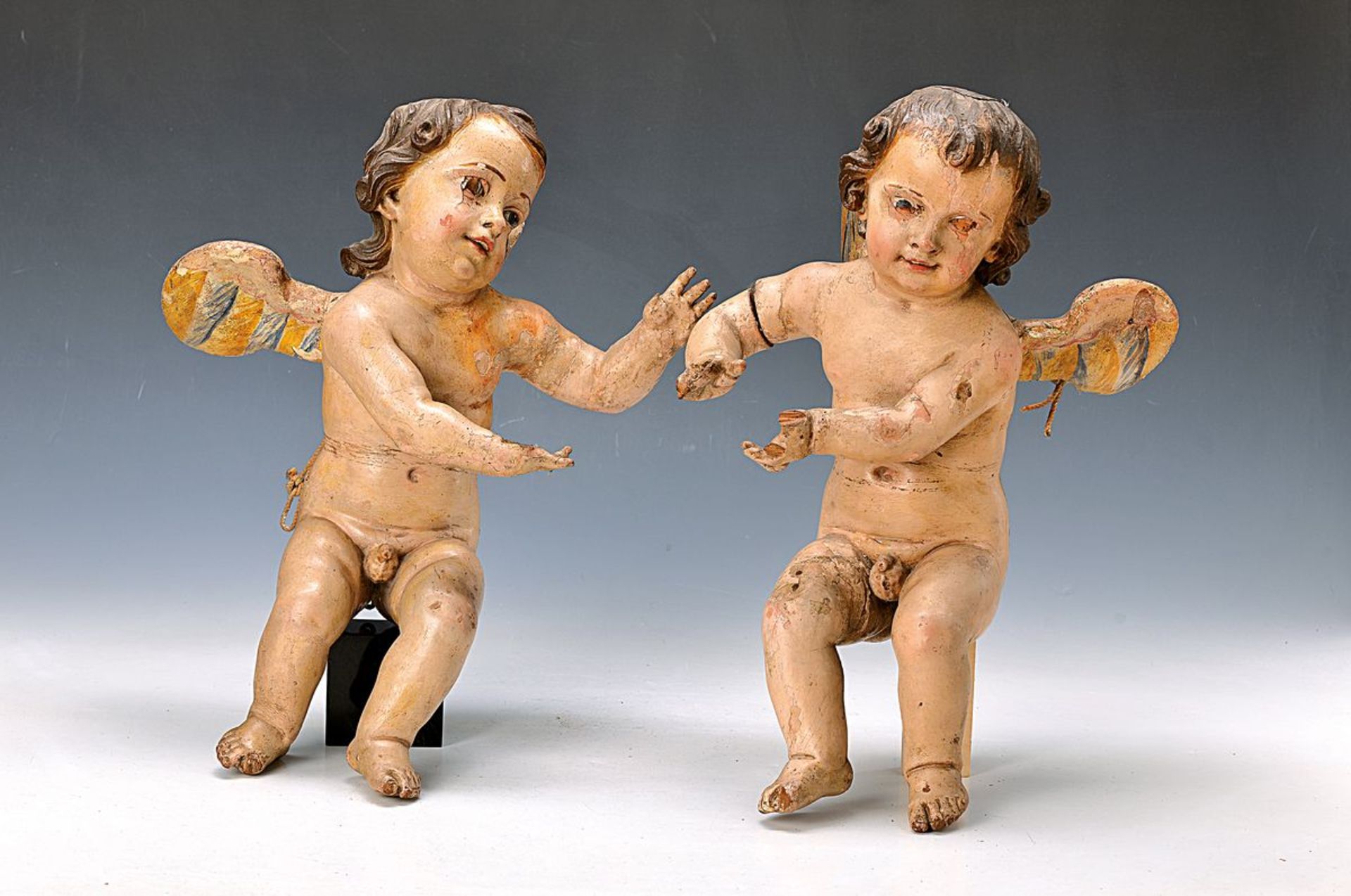 couple of baroque angels, Southern Germany, around 1750, basswood carved, with glass eyes, damaged